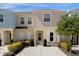 Inviting townhouse with tidy front landscaping and concrete driveway, perfect for easy living at 4730 Coral Castle Dr, Kissimmee, FL 34746
