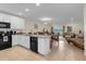 Open kitchen with an island connects to dining and living areas with lake views at 4730 Coral Castle Dr, Kissimmee, FL 34746