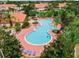 Aerial view of the community pool surrounded by lush landscaping and homes at 4732 Coral Castle Dr, Kissimmee, FL 34746