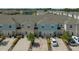 Aerial view of townhome showcasing landscaping, driveway, and other units in the community at 4732 Coral Castle Dr, Kissimmee, FL 34746