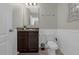 The bathroom features wainscoting, clean lines, and a modern design at 4732 Coral Castle Dr, Kissimmee, FL 34746