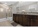 Bathroom boasts double sinks, stylish cabinets, and glass door shower at 4732 Coral Castle Dr, Kissimmee, FL 34746