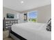 Bright bedroom with a gray dresser, TV, and water views from the window at 4732 Coral Castle Dr, Kissimmee, FL 34746