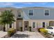Charming two-story townhome with manicured landscaping, neutral color palette, and a private driveway at 4732 Coral Castle Dr, Kissimmee, FL 34746