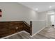 Hallway at the top of the stairs with wood accent wall and gray walls at 4732 Coral Castle Dr, Kissimmee, FL 34746
