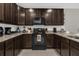 Well-equipped kitchen features dark wood cabinetry and granite countertops at 4732 Coral Castle Dr, Kissimmee, FL 34746