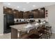 Beautiful kitchen with dark cabinetry, granite counters, and stainless appliances at 4732 Coral Castle Dr, Kissimmee, FL 34746