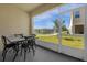 Relaxing screened patio with table and chairs overlooking the water at 4732 Coral Castle Dr, Kissimmee, FL 34746