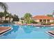 Community pool area with lounge chairs and palm trees, creating a relaxing oasis at 4732 Coral Castle Dr, Kissimmee, FL 34746