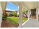 Backyard featuring a well-manicured lawn, lush plants, and a covered patio at 8896 Reymont St, Orlando, FL 32827