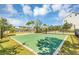 Image of a well-maintained basketball court with green turf, a fence and lush greenery in the background at 8896 Reymont St, Orlando, FL 32827