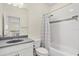 Bright bathroom features a shower-over-tub with decorative tile and a modern vanity at 8896 Reymont St, Orlando, FL 32827