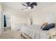Bright bedroom with plush carpeting, a ceiling fan, and an ensuite bathroom at 8896 Reymont St, Orlando, FL 32827