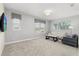 Bright bonus room with neutral tones, large windows, and comfortable seating at 8896 Reymont St, Orlando, FL 32827