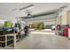 Spacious garage with overhead storage and a view of the house across the street at 8896 Reymont St, Orlando, FL 32827