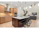 Modern kitchen with stainless steel appliances, center island with barstool seating, and light wood cabinets at 8896 Reymont St, Orlando, FL 32827
