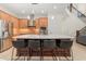 Bright kitchen featuring stainless steel appliances, center island with seating, and light hardwood floors at 8896 Reymont St, Orlando, FL 32827