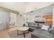 Open-concept living area with high ceilings, modern decor, and seamless flow to kitchen at 8896 Reymont St, Orlando, FL 32827