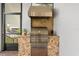 Outdoor kitchen features a built-in grill, granite counters, and stainless steel hood at 8896 Reymont St, Orlando, FL 32827