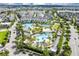 A high angle view showcasing the community pools, palm trees and green spaces in the neighborhood at 8896 Reymont St, Orlando, FL 32827