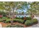Peaceful community pool featuring a splashpad, lounge seating, lush landscaping, palm trees, a modern clubhouse, and a clear blue sky at 8896 Reymont St, Orlando, FL 32827