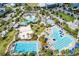 Aerial image displaying community pools, a sand volleyball court, and well maintained landscaping at 8896 Reymont St, Orlando, FL 32827