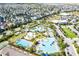 Overhead view of a community pool featuring palm trees and manicured landscaping near many homes at 8896 Reymont St, Orlando, FL 32827