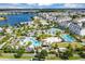 An aerial view showcasing the multiple community pools, palm trees and amenities near a lake at 8896 Reymont St, Orlando, FL 32827