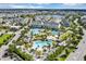 A high angle view of the community pools, townhomes and palm trees near a lake in the community at 8896 Reymont St, Orlando, FL 32827