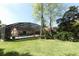 Lush backyard with screened-in pool area, offering a perfect blend of relaxation and recreation at 1157 Duncan Dr, Winter Springs, FL 32708
