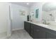Bathroom featuring double vanity with a marble countertop and white framed mirrors at 1157 Duncan Dr, Winter Springs, FL 32708