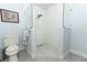 Modern bathroom featuring a walk-in shower with glass partition and gray tiling at 1157 Duncan Dr, Winter Springs, FL 32708