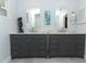 Bathroom featuring double vanity with a marble countertop and white framed mirrors at 1157 Duncan Dr, Winter Springs, FL 32708
