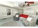 Relaxing bedroom features a cozy seating area, ceiling fan, and ample closet space at 1157 Duncan Dr, Winter Springs, FL 32708