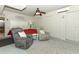 Relaxing bedroom features a cozy seating area, ceiling fan, and ample closet space at 1157 Duncan Dr, Winter Springs, FL 32708