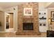 Living room featuring a brick fireplace, built-in shelving, and an open doorway at 1157 Duncan Dr, Winter Springs, FL 32708
