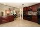 Gourmet kitchen with dark wood cabinets, stainless steel appliances, and breakfast bar seating at 1157 Duncan Dr, Winter Springs, FL 32708