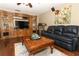 Comfortable living room with hardwood floors, ceiling fan and large TV entertainment center at 1157 Duncan Dr, Winter Springs, FL 32708