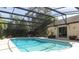 Inviting screened-in pool with a spacious patio and lush landscaping at 1157 Duncan Dr, Winter Springs, FL 32708