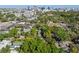 Aerial view showcases urban skyline, lush green trees, and charming neighborhood homes at 128 Waverly Pl # 128, Orlando, FL 32806