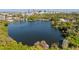 Stunning aerial view of a serene lake surrounded by lush greenery and a city skyline at 128 Waverly Pl # 128, Orlando, FL 32806
