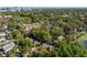 Aerial view highlights lush green landscape, charming homes, and urban tree canopy at 128 Waverly Pl # 128, Orlando, FL 32806