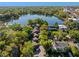 Aerial view of property showcasing lush green surroundings and lake, providing a serene setting at 128 Waverly Pl # 128, Orlando, FL 32806