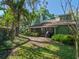 Secluded backyard featuring lush landscaping and a patio with grill, perfect for outdoor gatherings at 128 Waverly Pl # 128, Orlando, FL 32806