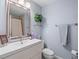Bathroom featuring blue walls, stylish fixtures, a vanity, and a shower curtain at 128 Waverly Pl # 128, Orlando, FL 32806