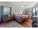 Spacious bedroom with hardwood floors, ceiling fan, and ample natural light from large windows at 128 Waverly Pl # 128, Orlando, FL 32806