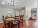 Dining room with hardwood floors, modern lighting, and a view into the living room and fireplace at 128 Waverly Pl # 128, Orlando, FL 32806
