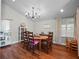 Bright dining room features hardwood floors, chandelier, and large windows with natural light at 128 Waverly Pl # 128, Orlando, FL 32806