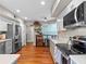 Renovated kitchen featuring stainless steel appliances, stone countertops, and hardwood floors at 128 Waverly Pl # 128, Orlando, FL 32806