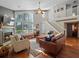 Bright living room featuring a vaulted ceiling, fireplace, and a staircase to the second floor at 128 Waverly Pl # 128, Orlando, FL 32806